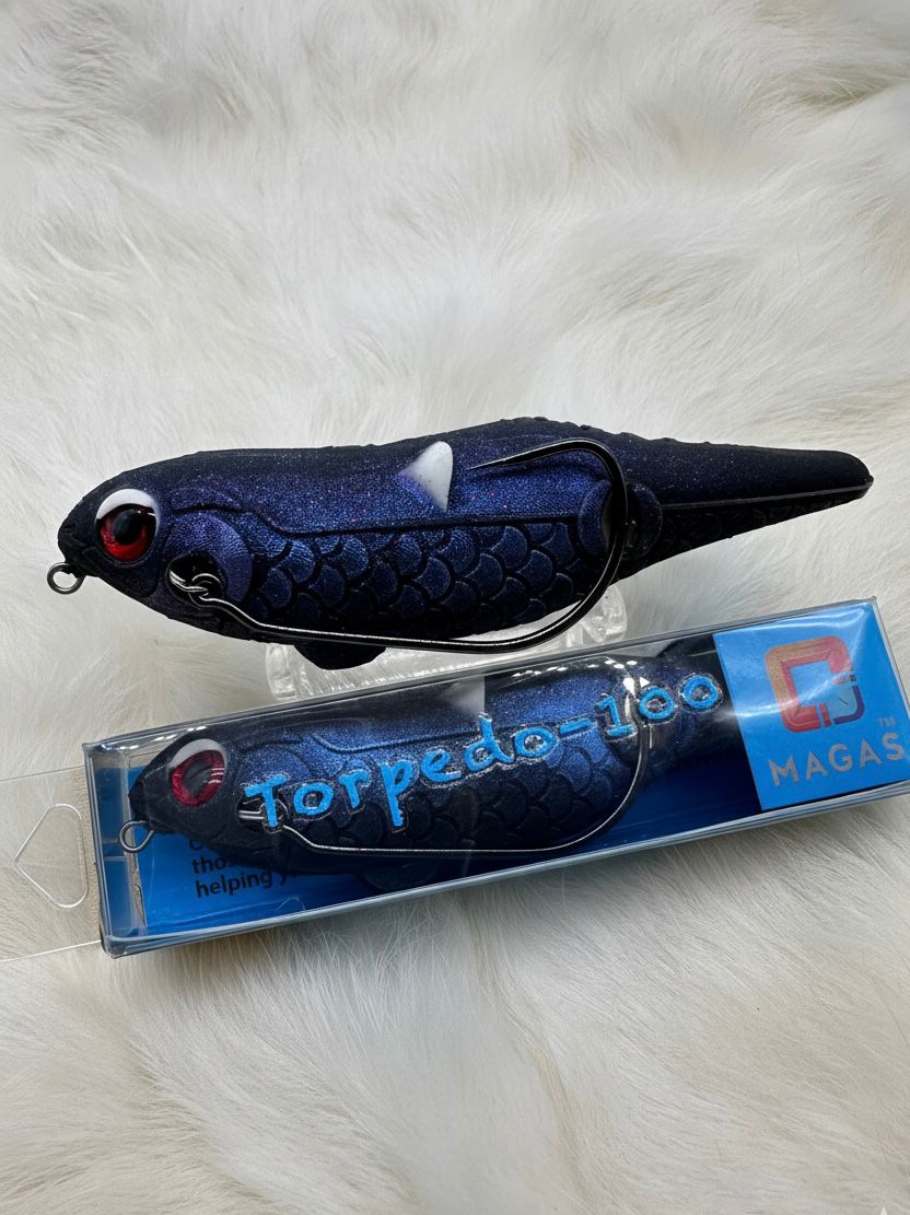 Toman giant snakehead caught with MAGAS Torpedo-100 Pencil Lure soft silicone anti-snag fishing lure near heavy cover, weeds, and shallow structure.